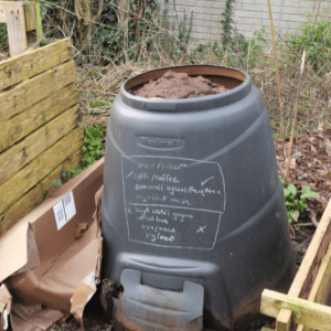 A compost bin full of used coffee grounds